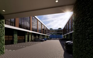 Binnenplaats van een modern bedrijfspand in Eindhoven met verdiepingsvloeren, grote glaspartijen en parkeerplaatsen onder een overkapping.
