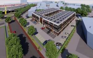Luchtbeeld van het nieuwbouwproject met meerdere bedrijfspanden in Eindhoven, gelegen naast een parkeergarage en groene omgeving.