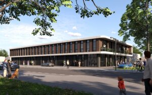 Zijaanzicht van een nieuwbouw bedrijfsruimte in Rotterdam met verticale gevelindeling en meerdere overheaddeuren langs de straatzijde.